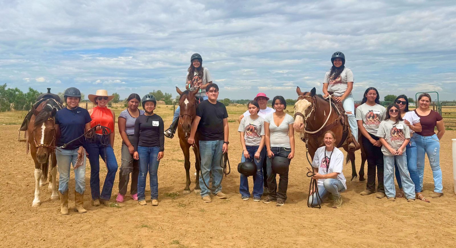 The cohort gathered in the arena on the last day, some riders mounted on horses and others standing beside them